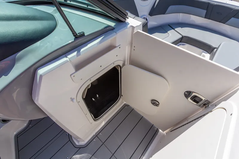 Slide: The Image of 2026 Chaparral 23 SSi boat interior with open storage compartment and seating area. - 29
