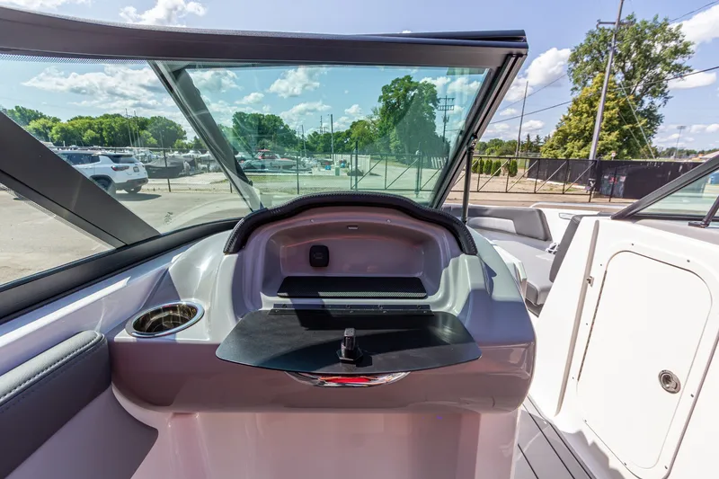 Slide: The Image of 2026 Chaparral 23 SSi boat interior with windshield and storage compartment. - 26