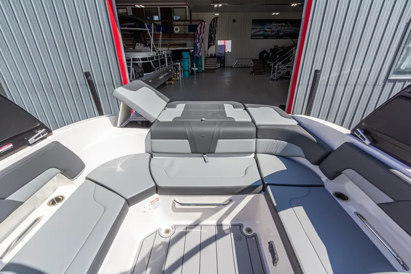 Slide: The Image of 2026 Chaparral 23 SSi boat interior with gray seating, docked in a marina. - 17