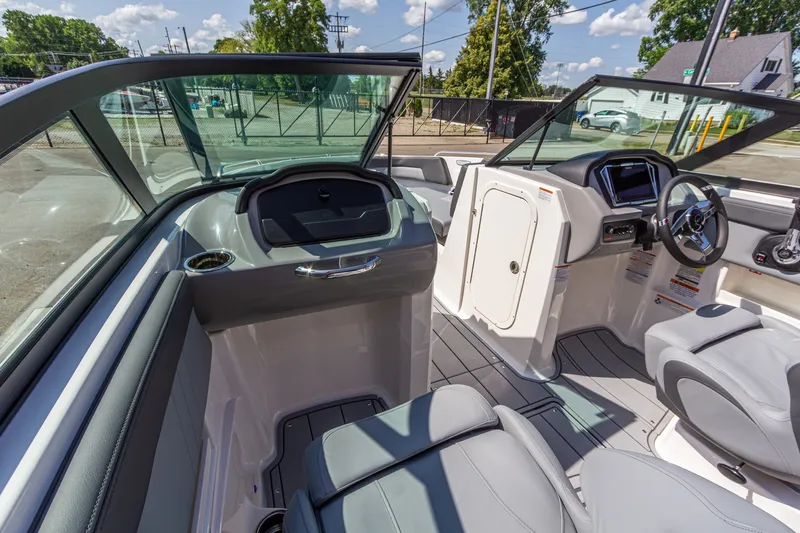 Slide: The Image of Interior view of 2026 Chaparral 23 SSi boat, featuring sleek seating and modern dashboard. - 25