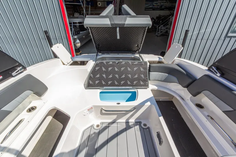 Slide: The Image of 2026 Chaparral 23 SSi boat interior with open storage compartments and seating. - 15