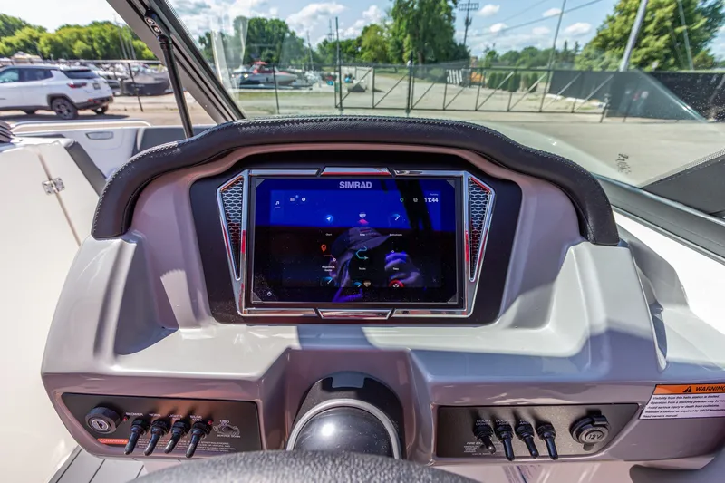 Slide: The Image of Dashboard of 2026 Chaparral 23 SSi boat with Simrad display and controls. - 24