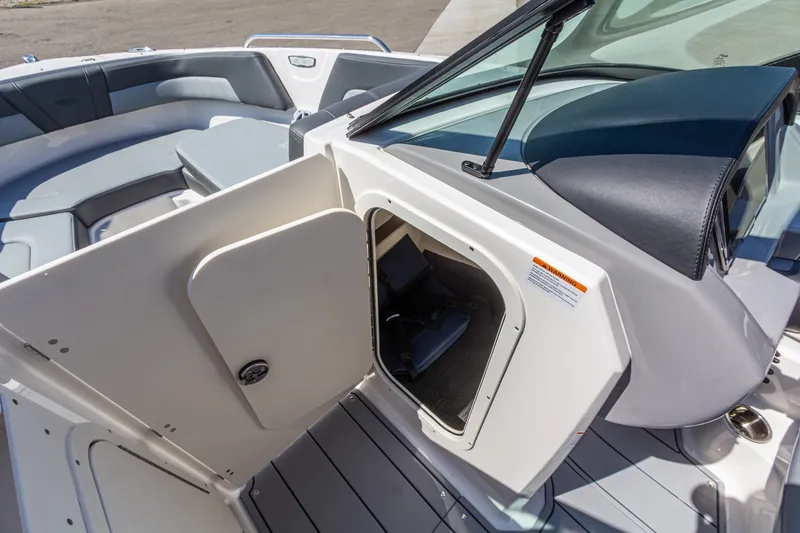 Slide: The Image of 2026 Chaparral 23 SSi boat interior with open storage compartment and seating area. - 28