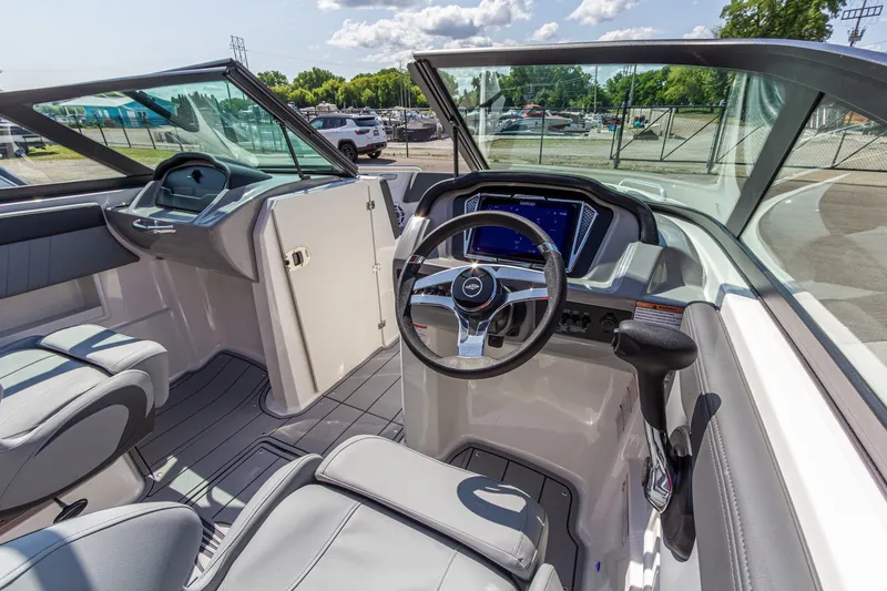 Slide: The Image of Interior of 2026 Chaparral 23 SSi boat with modern steering and dashboard. - 23