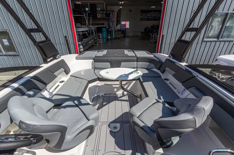 Slide: The Image of 2026 Chaparral 23 SSi boat interior with gray seating and a central table. - 22