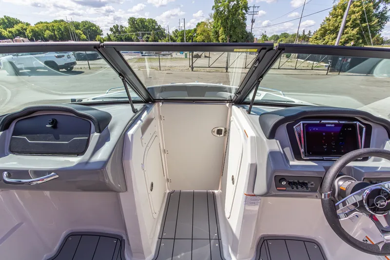 Slide: The Image of 2026 Chaparral 23 SSi boat interior with modern dashboard and steering wheel. - 27