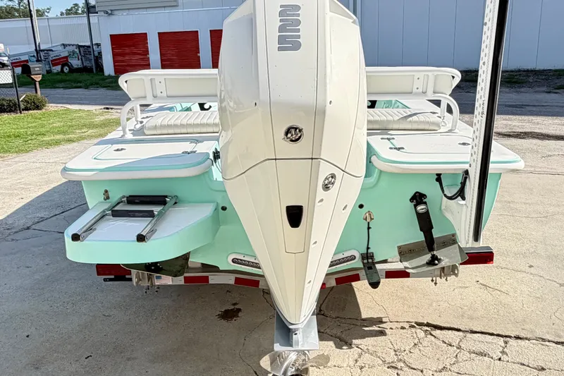 Slide: The Image of 2023 Egret 21 Moccasin boat with powerful outboard motor, parked on a trailer. - 16