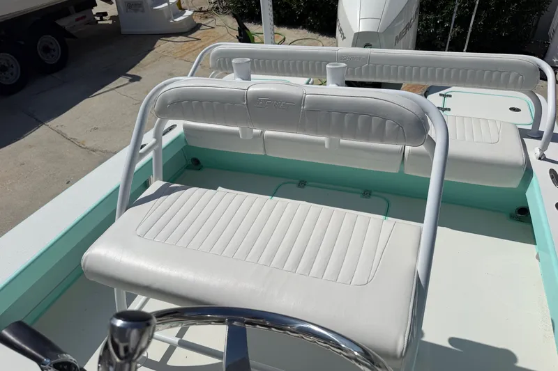 Slide: The Image of Interior of 2023 Egret 21 Moccasin boat with white cushioned seating. - 32