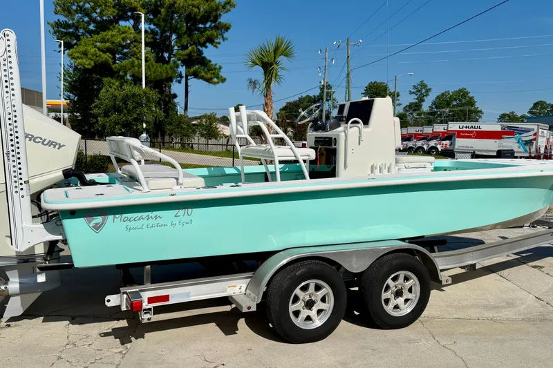Slide: The Image of 2023 Egret 21 Moccasin boat on trailer, mint green, parked outdoors. - 14