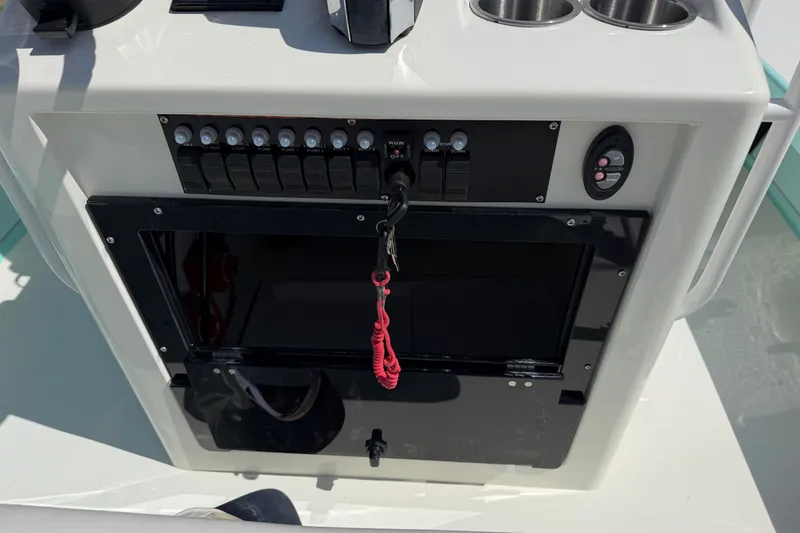 Slide: The Image of Control panel of 2023 Egret 21 Moccasin boat with switches and key tether. - 43