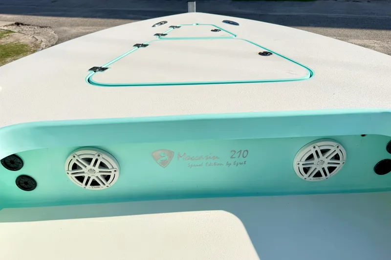 Slide: The Image of 2023 Egret 21 Moccasin boat deck with speakers and storage compartments. - 37