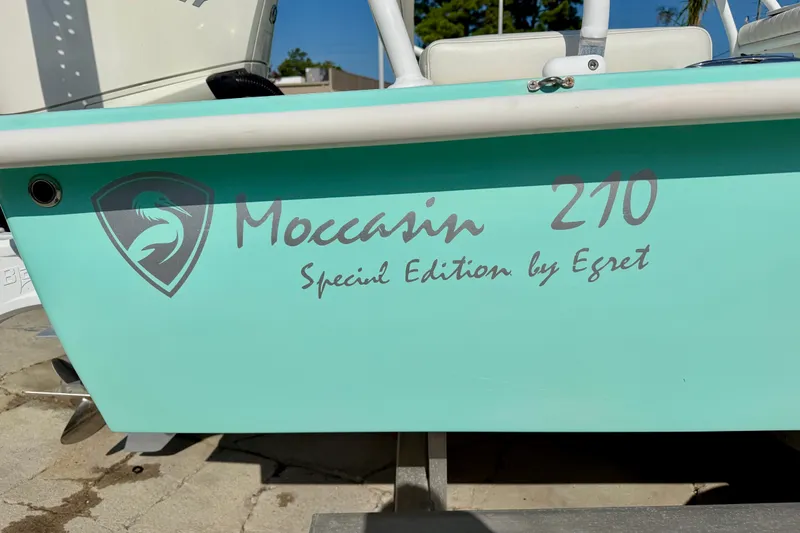 Slide: The Image of 2023 Egret Moccasin 210 boat, special edition, turquoise hull with logo and text. - 31