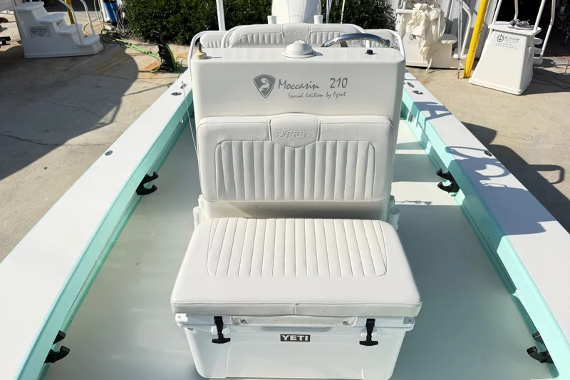 Slide: The Image of 2023 Egret 21 Moccasin boat interior with white seating and Yeti cooler. - 30