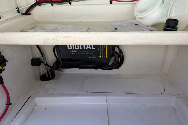 Slide: The Image of Interior view of 2023 Egret 21 Moccasin boat showing digital battery charger setup. - 40