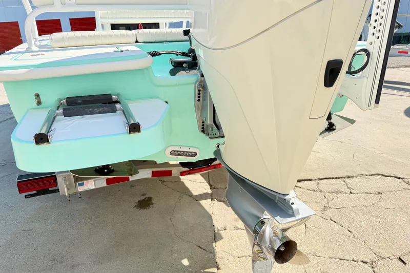 Slide: The Image of Rear view of 2023 Egret 21 Moccasin boat with outboard motor and swim platform. - 24