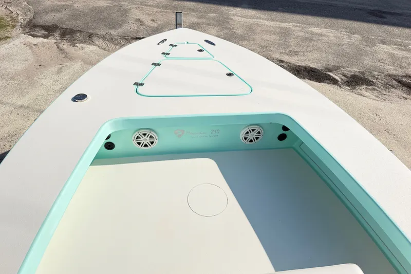 Slide: The Image of 2023 Egret 21 Moccasin boat deck with storage compartments and speakers. - 28