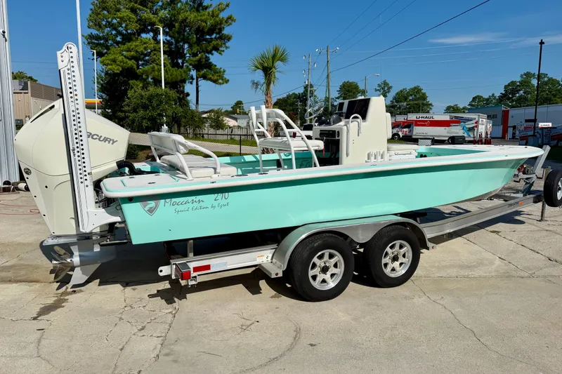Slide: The Image of 2023 Egret 21 Moccasin boat on trailer, light blue hull, parked outdoors. - 20