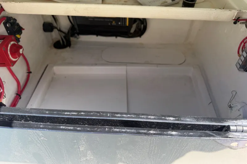 Slide: The Image of Storage compartment of 2023 Egret 21 Moccasin boat with wiring and battery switch. - 39