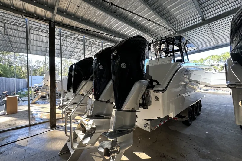 Slide: The Image of 2024 Invincible 38 Catamaran with powerful outboard engines in a covered storage area. - 4