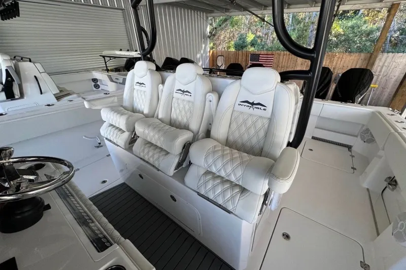 Slide: The Image of 2024 Invincible 38 Catamaran interior with luxurious white seating and modern design. - 6