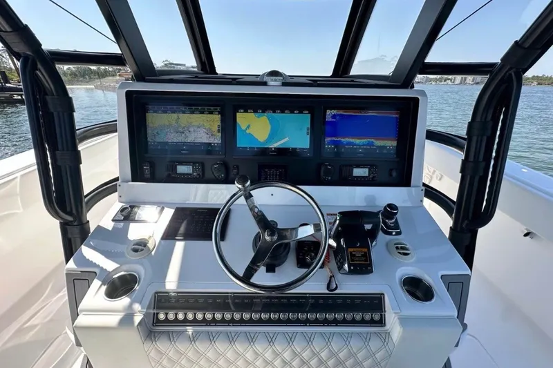 Slide: The Image of 2024 Invincible 38 Catamaran helm with advanced navigation displays and controls. - 8