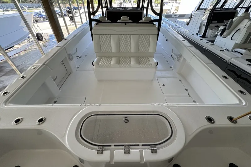 Slide: The Image of 2024 Invincible 38 Catamaran interior with white seating and spacious deck layout. - 3