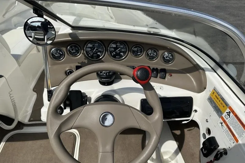 Slide: The Image of 2006 Larson 180 I/O boat dashboard with steering wheel and instrument panel. - 15