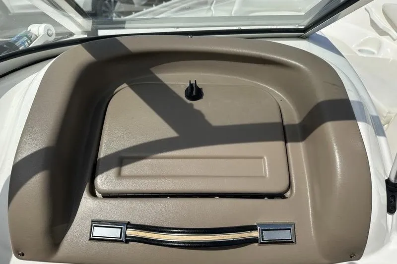 Slide: The Image of Dashboard of a 2006 Larson 180 I/O boat with beige panel and storage compartment. - 13