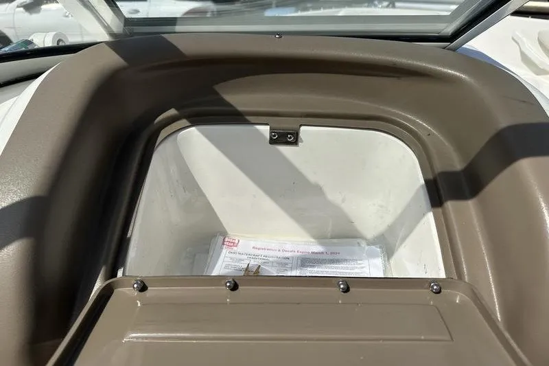 Slide: The Image of Open storage compartment on a 2006 Larson 180 I/O boat, containing documents. - 3