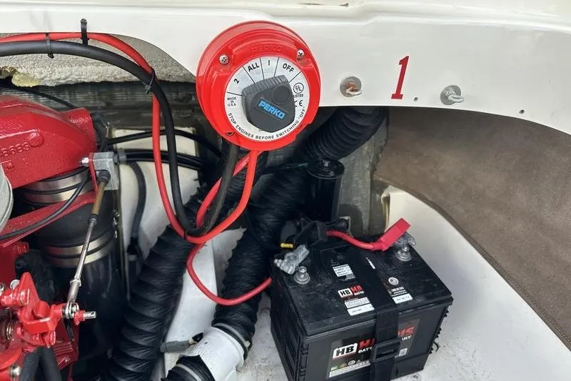 Slide: The Image of 2006 Larson 180 I/O boat battery compartment with Perko switch and wiring. - 11