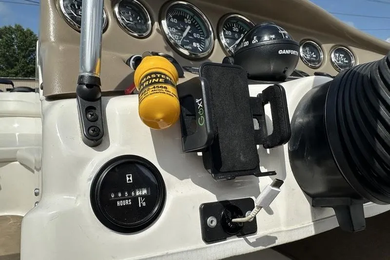 Slide: The Image of Dashboard of a 2006 Larson 180 I/O boat with gauges and accessories. - 4