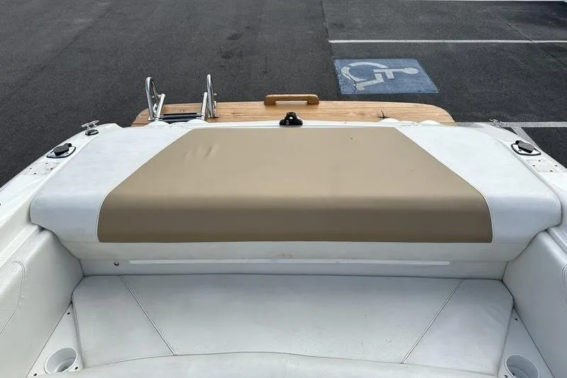 Slide: The Image of Rear view of a 2006 Larson 180 I/O boat with beige and white seating. - 21