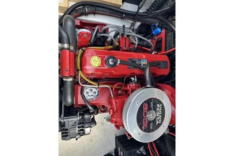 Slide: The Image of Engine of a 2006 Larson 180 I/O boat, featuring a red Volvo Penta 3.0GL. - 2
