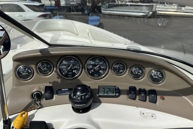 Slide: The Image of Dashboard of a 2006 Larson 180 I/O boat with gauges and compass. - 10
