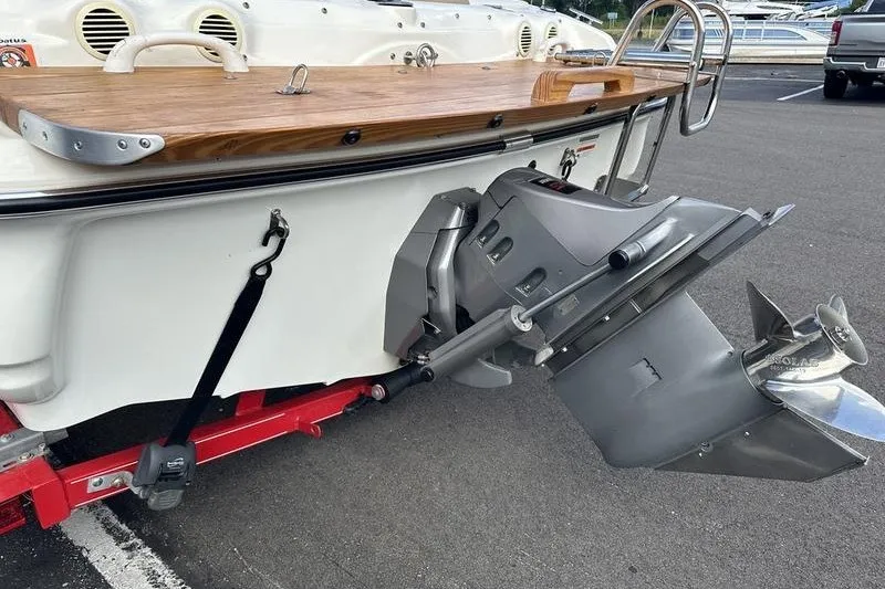 Slide: The Image of 2006 Larson 180 I/O boat stern with outboard motor on a trailer. - 12