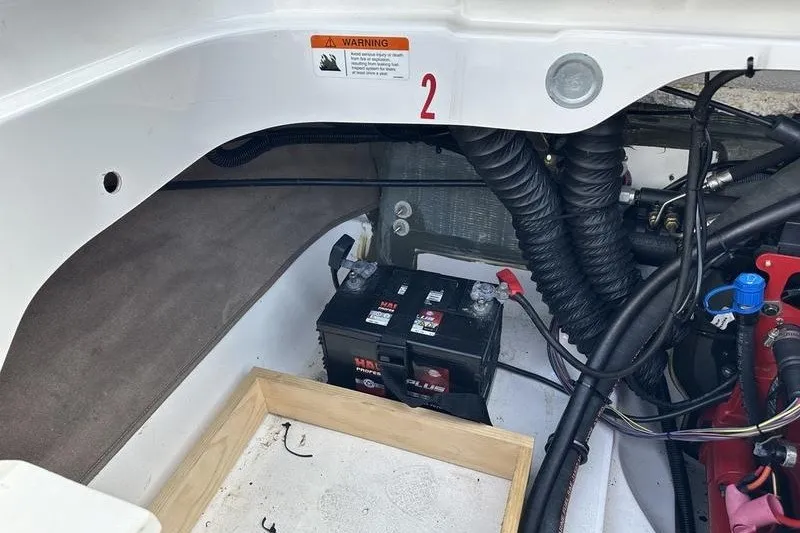 Slide: The Image of 2006 Larson 180 I/O boat engine compartment with battery and wiring. - 16