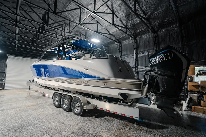 Slide: The Image of 2020 Concept 44' Cuddy Cabin boat in a warehouse, featuring a powerful outboard engine. - 67