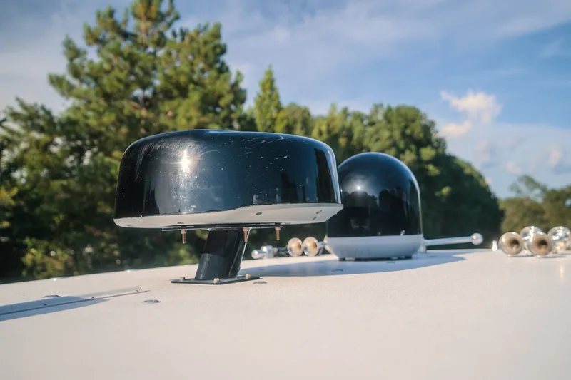 Slide: The Image of Close-up of radar equipment on 2020 Concept 44' Cuddy Cabin boat, with trees in background. - 37