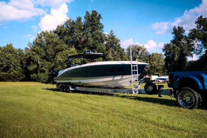 Slide: The Image of 2020 Concept 44' Cuddy Cabin boat on trailer, parked on grassy field. - 11