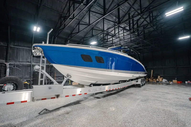 Slide: The Image of Blue 2020 Concept 44' Cuddy Cabin boat on trailer in warehouse. - 66