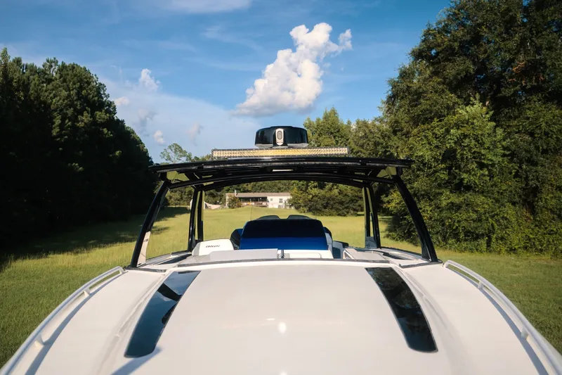 Slide: The Image of 2020 Concept 44' Cuddy Cabin boat in a grassy field, surrounded by trees. - 25