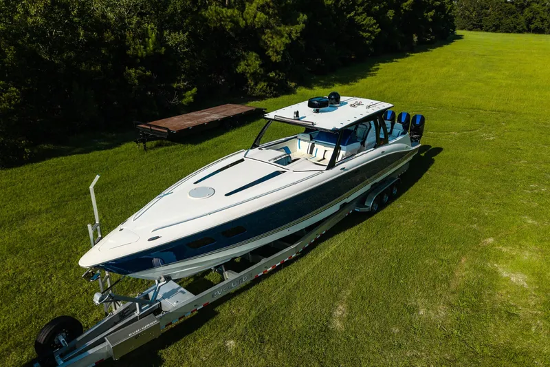 Slide: The Image of 2020 Concept 44' Cuddy Cabin boat on trailer in grassy area. - 9