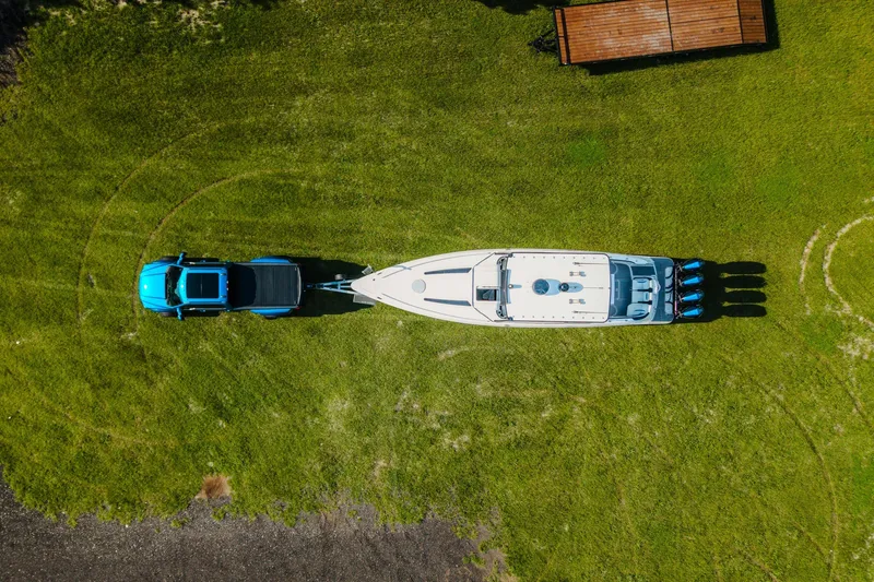 Slide: The Image of Aerial view of 2020 Concept 44' Cuddy Cabin boat towed by a blue truck on grass. - 6
