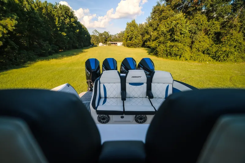 Slide: The Image of 2020 Concept 44' Cuddy Cabin boat with luxurious seating, set in a lush green landscape. - 53