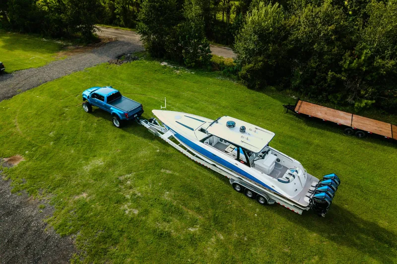 Slide: The Image of Aerial view of a 2020 Concept 44' Cuddy Cabin boat on a trailer, towed by a blue truck. - 5