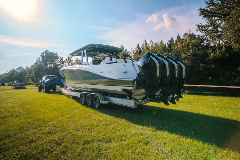 Slide: The Image of 2020 Concept 44' Cuddy Cabin boat on trailer, sunny day, grassy field. - 19