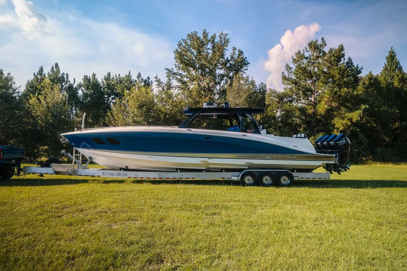 The Image of 2020 Concept 44' Cuddy Cabin boat on trailer, parked on grassy field. - 1