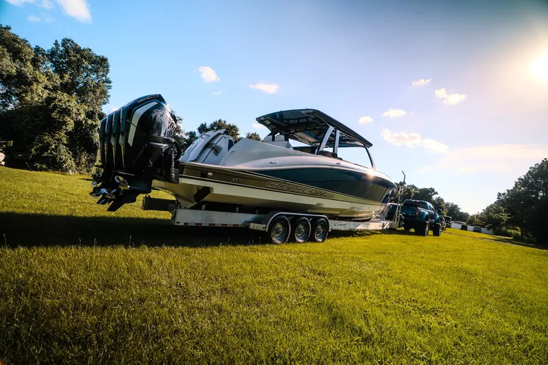 Slide: The Image of 2020 Concept 44' Cuddy Cabin boat on trailer, parked on grassy field. - 17