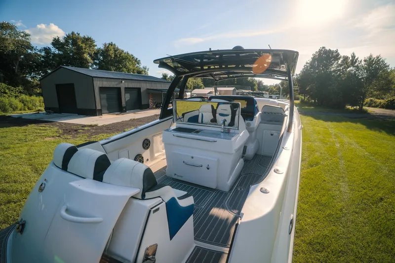 Slide: The Image of 2020 Concept 44' Cuddy Cabin boat on grassy area near a garage. - 65