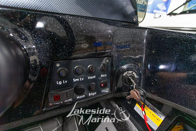 Slide: The Image of Control panel of a 2027 Recon 985 DC boat with ignition keys inserted. - 22